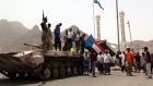  South Yemenis stand on a tank used by militiamen loyal to the Saudi-backed Yemeni president, Abed Rabbo Mansour Hadi, following clashes with Houthi fighters in the  port city of Aden on Wednesday. Photograph: EPA
