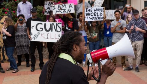 Muhiydin Moye D'Baha addresses the demonstrators at a rally to protest the death of Walter Scott, who was killed by police in a shooting  in North Charleston, South Carolina. It is one of several high profile killings of African Americans by white police officers in the US to have rocked the country in recent months.  Photograph: Richard Ellis/Getty Images
