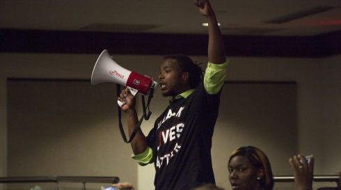 Muhiydin Moye D'Baha of the Black Lives Matter movement, uses a bull horn to make a point during a news conference with North Charleston Police and Government officials in North Charleston, South Carolina. Demonstrators rallied on Wednesday against what they described as a culture of police brutality in South Carolina. Photograph: Randal Hill/Reuters
