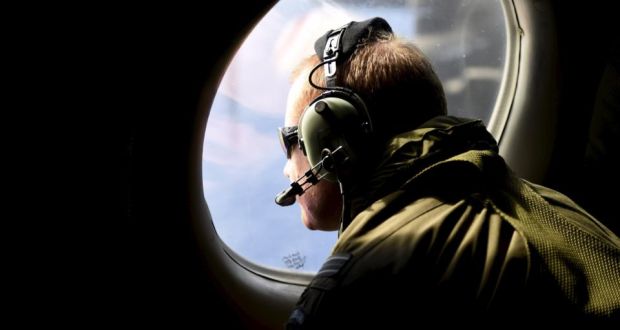 A crew member looks out an observation window aboard a Royal New Zealand Air Force  search aircraft as it flies over the southern Indian Ocean looking for debris from missing Malaysian Airlines flight MH370. Photograph: Reuters/Richard Polden