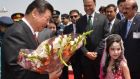China’s president Xi Jinping receives flowers from a Pakistani girl after arriving at Nur Khan air base in Rawalpindi.  Mr Xi  arrived in Islamabad on Monday for his first state visit to Pakistan, where he is expected to announce investment of €42.77 billion. Photograph:  AFP/Press Information Department, Pakistan