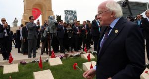 President Michael D Higgins places carnations on the graves of  soldiers at the 57th Turkish Regiment cemetery and memorial site in Gallipoli. Photograph: Burhan Ozbilici/AP
