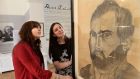 Sarah Costigan, Director of Development, and Joanna Perry, (left) curator of the exhibition, with a self portrait of Christy Brown. Photograph: Dara Mac Dónaill / The Irish Times