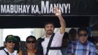 Filipino boxer Manny Pacquiao waves to crowds after arriving back in Manila following his defeat to Floyd Mayweather Jr in Las Vegas. Photo: Aaron Favila/AP