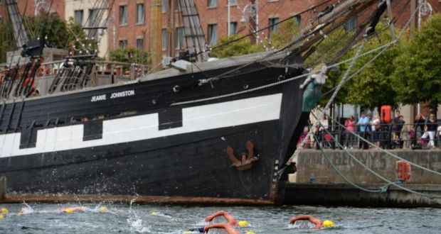 Passing the Jeanie Johnston during the 94th Liffey Swim – the ship was valued less than five months ago at €700,000, but costs €240,000 a year to run as a tourist attraction. Photograph: The Irish Times