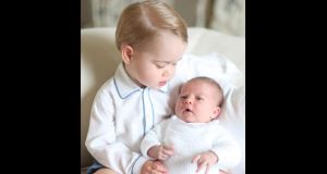 Britain’s Princess Charlotte is held by her brother Prince George in a photograph taken by their mother the Duchess of Cambridge in mid-May at Anmer Hall in Norfolk. Photograph: Duchess of Cambridge via PA Wire.