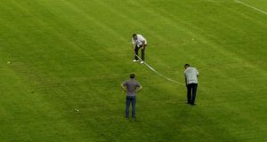 Police officers take measurements on the pitch where the faint pattern of a swastika is seen after the behind closed doors Euro 2016 qualifier between Croatia and Italy at the Poljud Stadium in Split. The Group H fixture was played without any fans present after the Croatians had been given a one-match ban for prior offences. Photo: Antonio Bronic/ Reuters