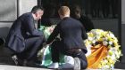 Philip Grant, consul general of Ireland to the Western United States (left) helps Neil Sands, president of the Irish Network Bay Area, lay an Irish flag atop two wreaths at the scene of a 4th-story apartment building balcony collapse in Berkeley, California. Six Irish students were killed and  at least seven other people were injured when an apartment balcony collapsed early on Tuesday in the Californian city of Berkeley. Photograph: Reuters 