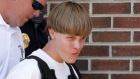 Police lead suspected shooter Dylann Roof (21) into the courthouse in Shelby, North Carolina. Roof  is accused of killing nine people at a Bible-study meeting in a historic African-American church in Charleston, South Carolina. Photograph: Jason Miczek/Reuters.