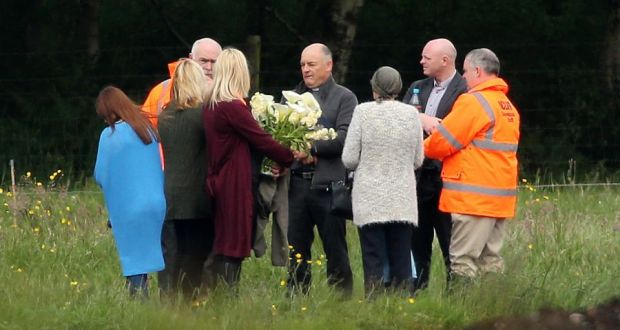 Local priest Father John O’Brien with members of Séamus Wright’s family at the site in Coghalstown, Co Meath. Photograph: PA