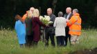 Local priest Father John O’Brien with members of Séamus Wright’s family at the site in Coghalstown, Co Meath. Photograph: PA