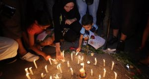 People gather for a candle light rally in solidarity with the victims of a deadly attack on the Imperial Marhabada hotel. Photograph: EPA 