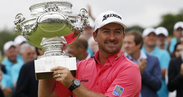 Northern Irishman golfer Graeme McDowell poses with his trophy after winning the 2014 Alstom Open de France on. Photo: Thomas Sampson/Getty Images