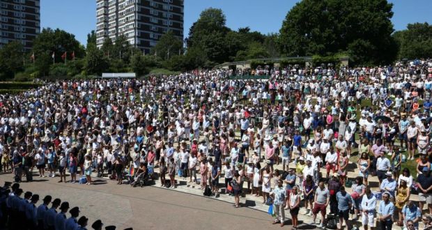  Spectators stand for a minutes silence to pay tribute to the victims of last week’s Tunisia beach attack on Murray Mound during Wimbledon Lawn Tennis Championships  in London today.  Photograph: Carl Court/Getty Images