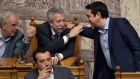 Greek prime minister Alexis Tsipras confers with Syriza colleagues during the vote at the Greek parliament in Athens. Photograph: Louisa Gouliamaki/AFP/Getty Images