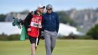  Paul Dunne talks to his caddie Alan Murray as they walk up the 16th fairway. Photograph: AFP Photo