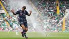 Ross County’s Richard Foster reacts as the pitch sprinklers are turned on midway through the Scottish  Premiership match at Celtic Park. Photograph:  Jeff Holmes/PA 