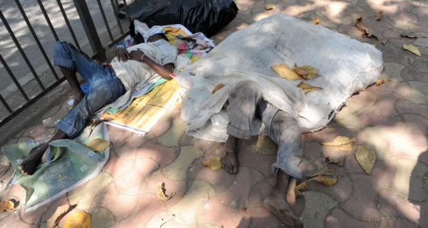 ‘Nothing is ordinary in India. And everything is diminished by comparison, even poverty.’ Above, two homeless people in Mumbai.  Photograph:  INDRANIL MUKHERJEE/AFP/Getty Images