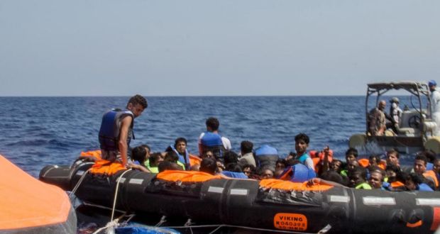 Surviving migrants are brought aboard Irish and Italian Navy life-boats in the area where their wooden vessel capsized and sank off the coast of Libya on Wednesday. Photograph: Reuters