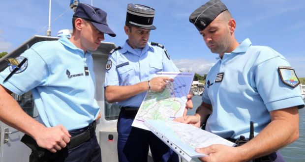 French maritime gendarmes look at a map as part of  the search for wreckage from the missing MH370 flight at the marina of Saint-Marie on the French island of  Réunion late last week. Photograph:  Richard Bouhet/AFP/Getty Images