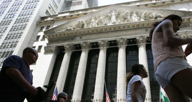 People walk by the New York Stock Exchange in New York. Photograph: Kena Betancur/AFP/Getty Images