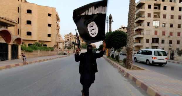 Spanish and Moroccan authorities have arrested 14 people suspected of recruiting fighters to join Islamic State in Syria and Iraq. Above an Islamic State member waves a flag linked to the group in Raqqa, Syria. Photograph: Reuters.