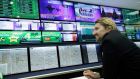 A man watches electronic displays at a Paddy Power bookmakers in London. Paddy Power and Betfair have announced they have agreed the terms of a possible merger. Photograph: Matthew Lloyd/Bloomberg