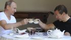  Vladimir Putin and Dmitry Medvedev toast with tea cups during breakfast in Sochi. Photograph: Reuters
