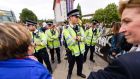 Police officers attempt to negotiate with people taking part in a protest to block the arrival of military vehicles to the upcoming arms fair at the ExCel centre in east London. Photograph: LEON NEAL/AFP/Getty Images