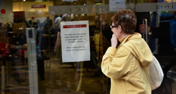  A passerby reads a notice on the door of Boyers & Co on North Earl Street, Dublin, after it was announced the store would close in January. Photograph: Dara Mac Dónaill/The Irish Times