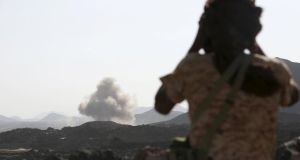 A soldier looks at smoke billowing from the site of a Saudi-led air strike on a Houthi position in the Yemeni frontline province of Marib on September 15th, 2015. Photograph:  REUTERS/Stringer