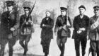 Thomas (left) and William Kent being marched by British soldiers across Fermoy bridge in May 1916