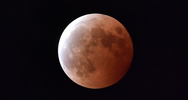 A  file photo taken on October 8th, 2014 shows a lunar eclipse as seen from Tokyo. A total eclipse of the moon will occur in the early hours of Monday morning and Irish skywatchers will have an excellent chance of seeing it. Photograph: Yoshikazu TSUNO/AFP/Getty Images.