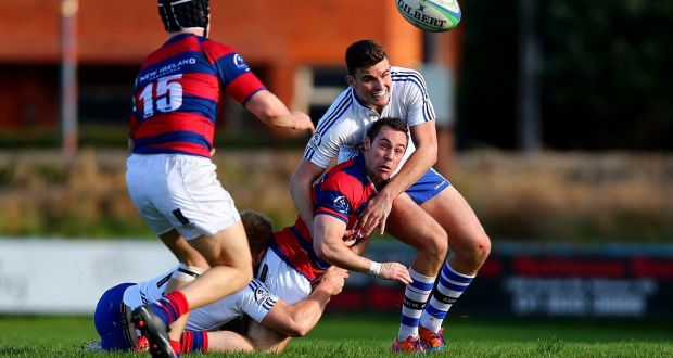 Rob McGrath of Clontarf is tackled by Ned Hobson of Cork Constitution during their  Ulster Bank League Division 1A match at Castle Avenue, Dublin. Photograph: Inpho  