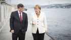 German chancellor Angela Merkel and Turkish prime minister Ahmet Davutoglu walk on the banks of the Bosphorus during a meeting in Istanbul on Sunday. Photograph: Guido Bergmann/Bundesregierung/Getty Images