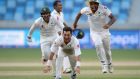 Pakistan spinner Yasir Shah  celebrates with team-mates Sarfraz Ahmed and Wahab Riaz after dismissing England’s Adil Rashid  to win the second Test  at Dubai Cricket Stadium. Photograph: Gareth Copley/Getty Images