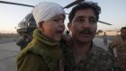 A soldier with an injured boy who was rescued with others from an earthquake stricken area of Chitral. Pakistan said it does not require international assistance to cope with the disaster. Photograph:  Fayaz Aziz/Reuters
