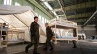 Members of the German Bundeswehr army prepare beds and tents for refugees inside a hangar of the former airport Tempelhof in Berlin. Photograph: Gregor Fischer/AFP/Getty Images