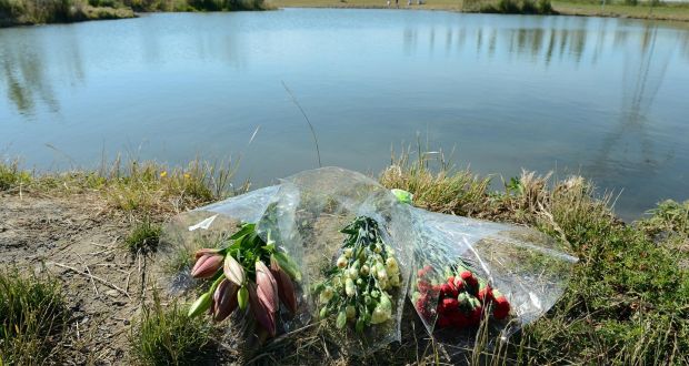 File photograph of flowers at the scene at Tyrrelstown park, west Dublin, where a Ahmed Bari drowned in the pond near his home. An inquest returned a verdict of accidental death. Photograph: Eric Luke 
