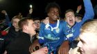 Finn Harps’  BJ Banda is swamped by fans at the final whistle after his goal secured Premier Division football for the Donegal  club in their play-off against Limerick at Finn Park in Ballybofey. Photograph: Lorcan Doherty/Inpho/Presseye