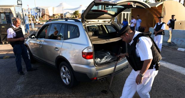A  policeman inspects a car at a checkpoint at Sharm el-Sheikh airport yesterday. Egypt said it stood to lose $280 million a month from the halt in Russian and British flights. Photograph: AFP/Getty Images