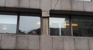 The damaged section of the concrete cladding on a  building on Trinity Street in Dublin. Photograph: Dan Griffin/The Irish Times