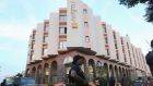 A Malian police officer stands guard in front of the Radisson hotel in Bamako. A UN official  was quoted as saying that peacekeepers aiding Malian soldiers had seen 27 bodies littering two floors.  Photograph: Joe Penney/Reuters