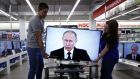  Vladimir Putin’s state-of-the-nation address on television in an electronics shop in Moscow. Photograph: Yurk Kochetkov/EPA 