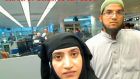 Tashfeen Malik, (left), and Syed Farook  pictured passing through Chicago’s O’Hare International Airport in this July 27th, 2014 photo. File photograph: US Customs and Border Protection/Reuters