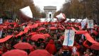Climate activists demonstrate with red umbrellas in Paris on Saturday. Photograph: Thibault Camus/PA