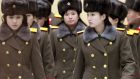 Members of the Moranbong Band of North Korea leaving Beijing International Airport after their concert in the Chinese capital was abruptly cancelled.  Photograph: Reuters/Kyodo