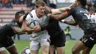 Ulster’s Irish winger Andrew Trimble is tackled by three Toulouse players during Sunday’s  clash at the Ernest Wallon Stadium in Toulouse. Photograph: Pascal Pavan/Getty
