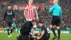 Liverpool’s Dejan Lovren receives treatment for a hamstring injury before going off in the Capital One Cup semi-final first leg at the Britannia Stadium. Photograph:   Martin Rickett/PA 