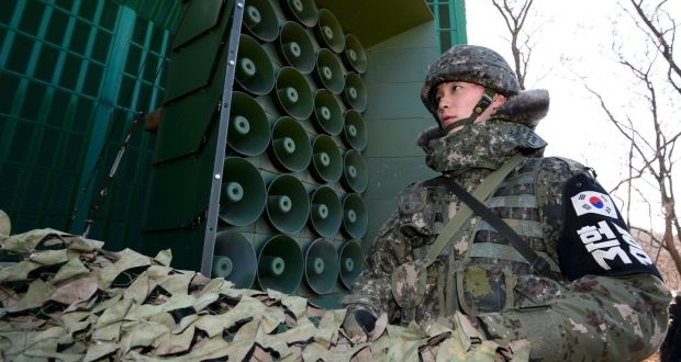 South Korean soldiers draw down a cover from loudspeakers, just south of the demilitarised zone separating North and South Korea, in Yeoncheon, South Korea. Photograph: Reuters